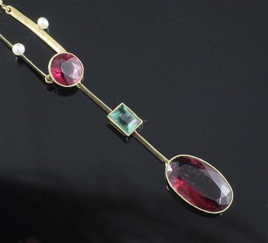 An Edwardian 15ct gold, deep pink tourmaline, emerald and seed pearl drop pendant necklace, drop overall 62mm.